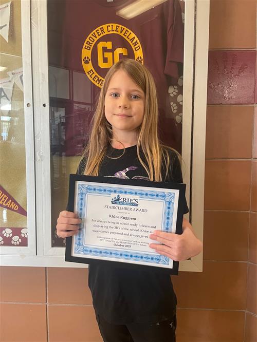 Khloe Ruggiero, Grover Cleveland's Stairclimber for October, poses with his award plaque.